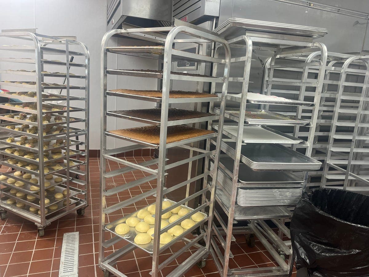 Back-of-house bakery kitchen with sheet pan racks at Los Portales
