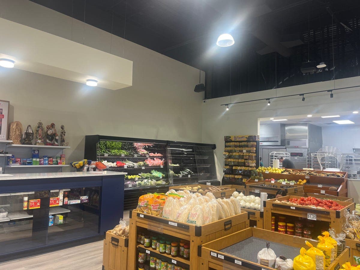 Fresh produce area with tomatoes, onions, and Virgin of Guadalupe at Los Portales